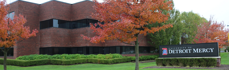 Front of Novi Campus building with University of Detroit Mercy sign.