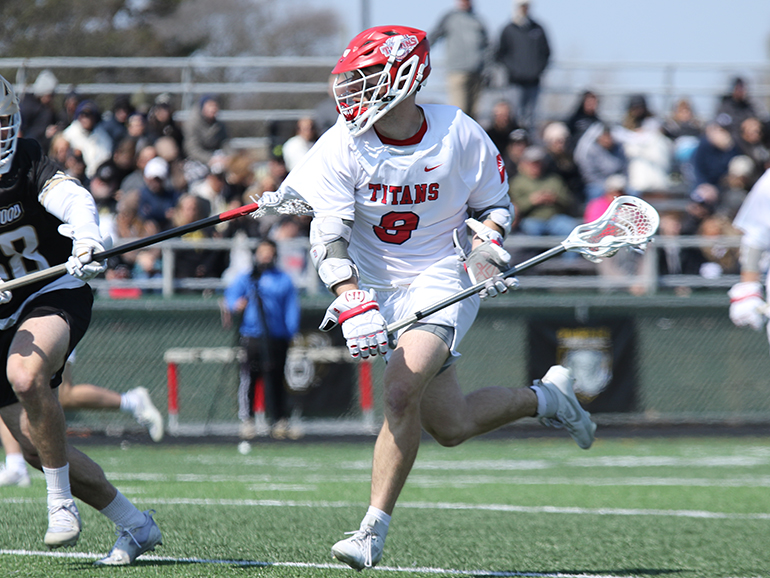 Ryan Birney wearing a Titans 9 uniform moves up the field during a lacrosse game.
