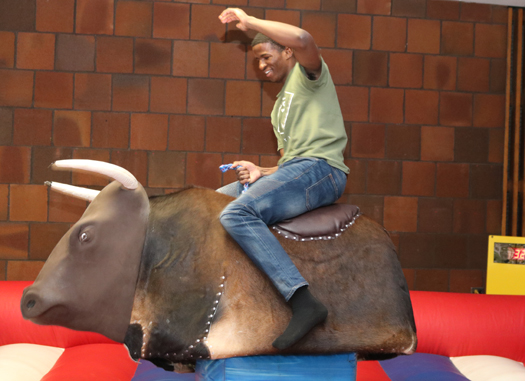 Detroit Mercy student riding a mechanical bull
