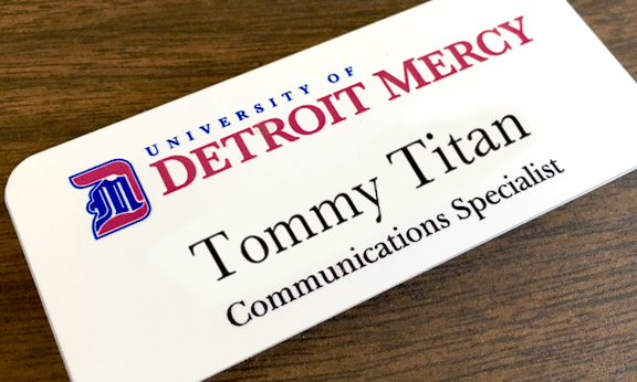 logo on Tommy titan name tag