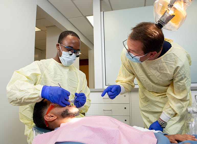 dental student about to  into patient's mouth