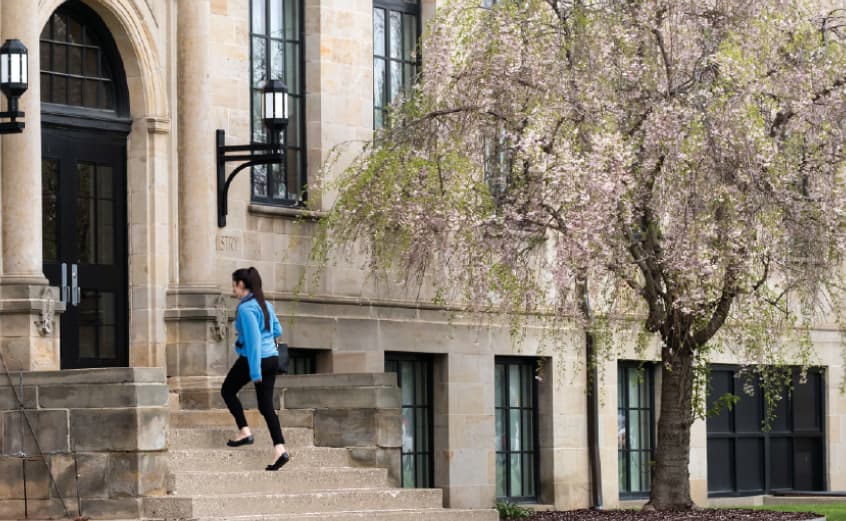 female student walking into Eng-Sci building