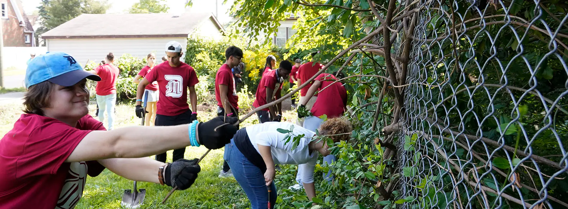 students pulling weeds at PTV service project
