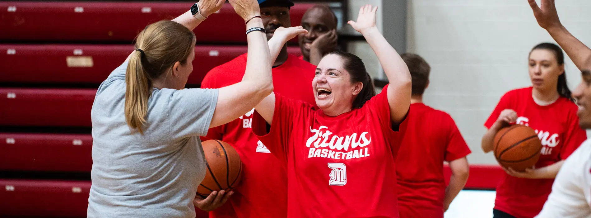 special titans camper high fiving a student volunteer