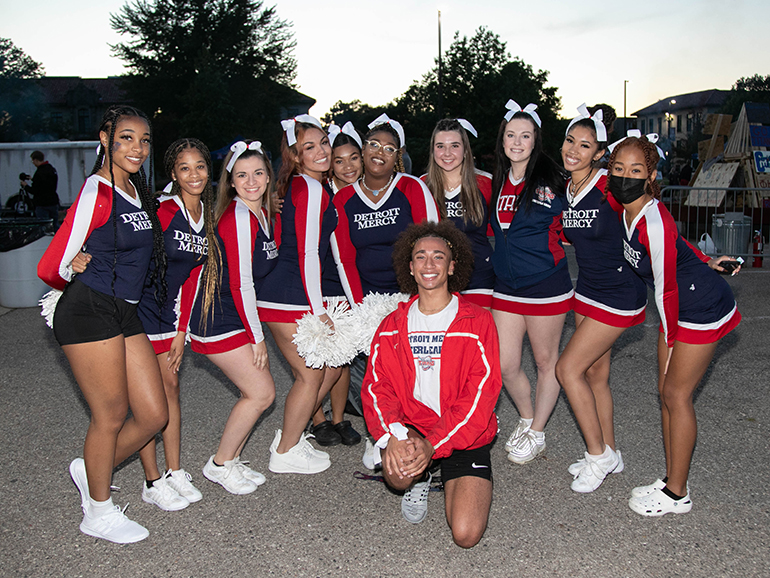 The Detroit Mercy cheer team poses for a group photo at Homecoming.