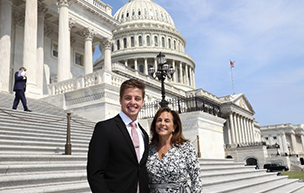 A photograph of Matthew Hutnick with Rep. Lisa McClain on the steps of government buildings in Washington, D.C.