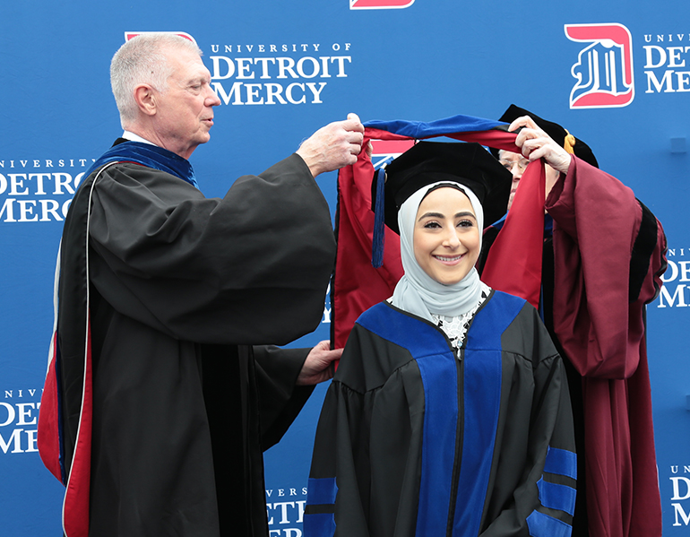 Class of 2021 graduate receives her master's hood.