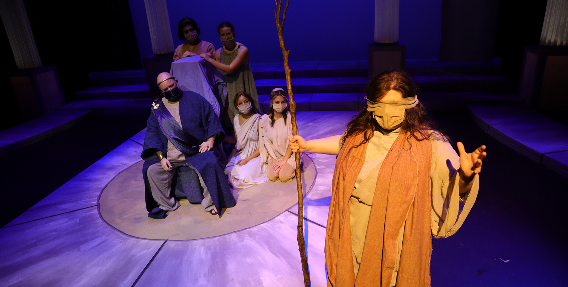 Oliva Swad, right, as Tiresias makes a prophecy to the king, Kreon and Chorus during Detroit Mercy Theatre Company's production of Antigone.