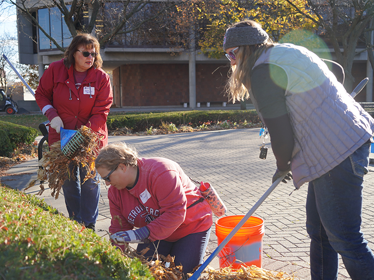 Three women help clean-up the McNichols Campus.