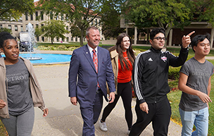 President Donald B. Taylor walks with students on Detroit Mercy's McNichols Campus.