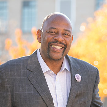 Earl Cureton smiles for a photo while visiting the McNichols Campus.