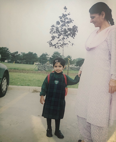 A young Mehar Soni holds the hand of her grandmother.