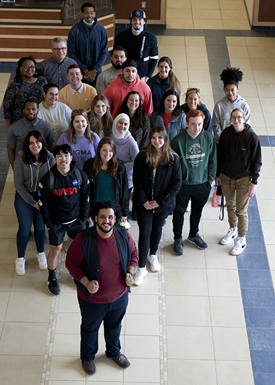 Mohammed Harhara, front, poses in front of fellow Titans, staff and faculty in the Student Fitness Center. 