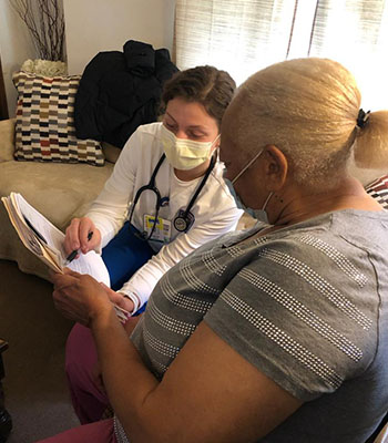 A Nursing student meets with a resident while participating in the McAuley School of Nursing's new partnership, Fresh Incentive Program.