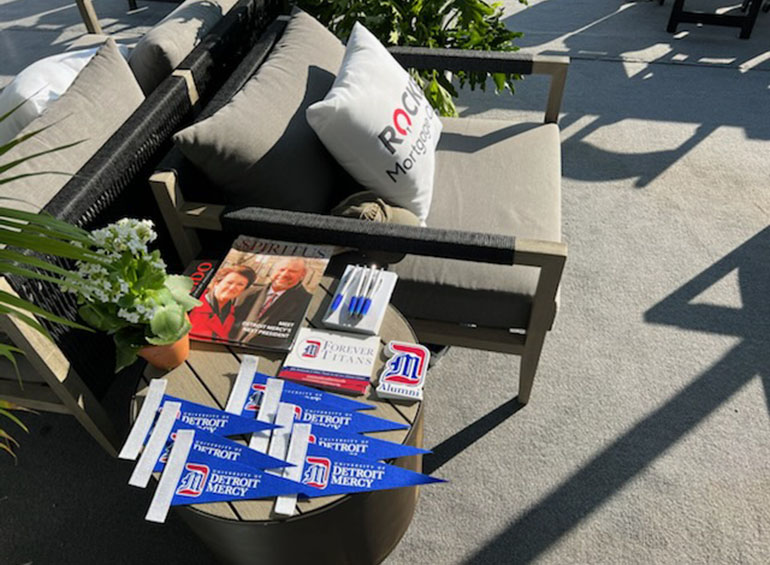 A chair and side table sit outside in a suite sponsored by the University of Detroit Mercy during the Rocket Mortgage Classic.