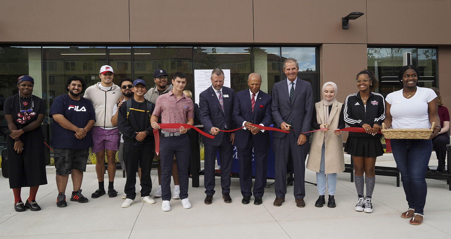 Students and administrators participate in a ceremonial ribbon cutting for the new Student Union.