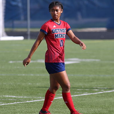 Women's soccer student-athlete Hannah Alexis surveys the field during a match at Titan Field.