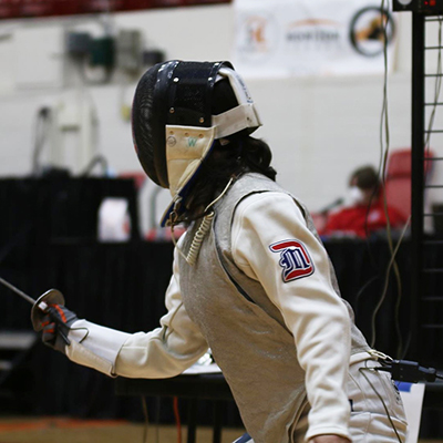 Women's fencing student-athlete Isabella Cole competes for the Titans in a fencing meet at Calihan Hall. 