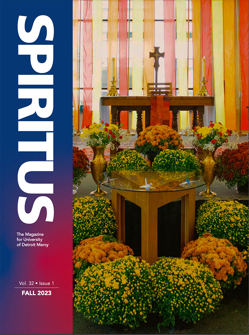 A cover for the Fall 2023 edition of Spiritus magazine, with a photo of flowers and a cross inside of the Student Fitness Center featured.