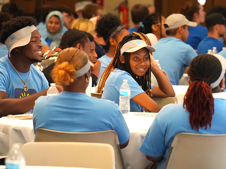 More than a dozen high school students sit inside of the Ballroom of the Student Union.