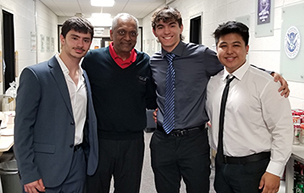 Event organizer Sajay Rai, second from left, poses with the first place team of Mark Formosa, left, JP Martin and Preston Duller for a photograph.