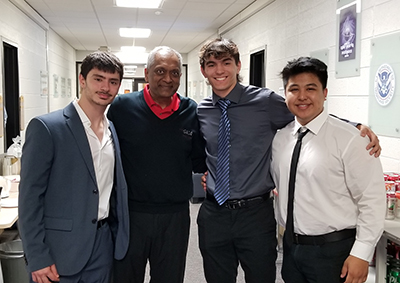 Event organizer Sajay Rai, second from left, poses with the first place team of Mark Formosa, left, JP Martin and Preston Duller for a photograph.