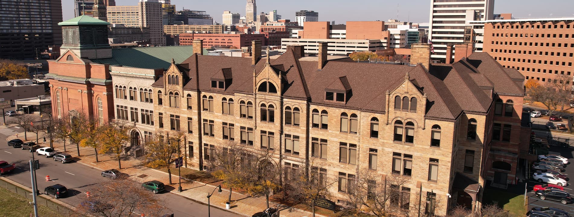 An aerial photo of the School of Law in downtown Detroit with cars and other buildings pictured on a sunny day.