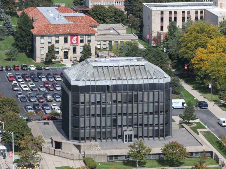 An aerial photo of part of the McNichols Campus with the Fisher Building in the foreground and other cars, trees and buildings beyond.