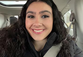 Isabelle Francis takes a selfie in a vehicle.