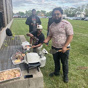 Latinx Student Union members prepare to grill food during the carne asada event.