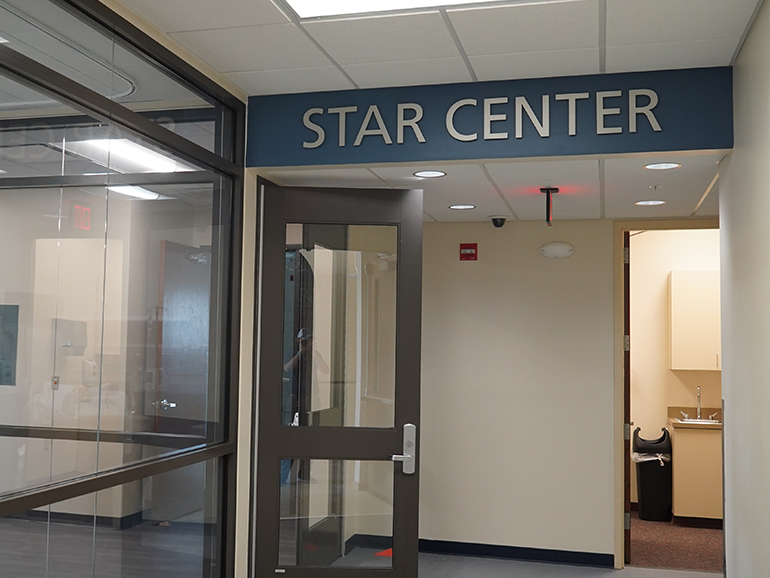 The entrance of the STAR Center inside of the College of Health Professions building, with big letters at the front reading STAR CENTER.