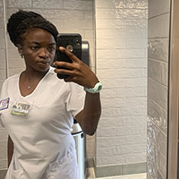 Favour Nwaneri takes a selfie in her UDM nursing scrubs.