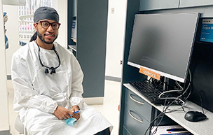 Trey Hester sits in a dental clinic station, ready to work.