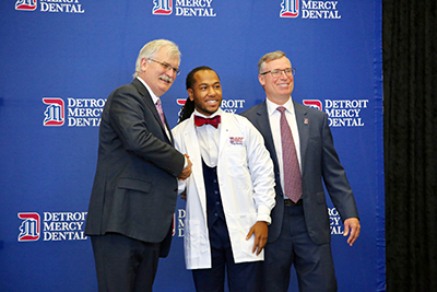 Trey Hester poses for a photograph with UDM School of Dentistry administration.