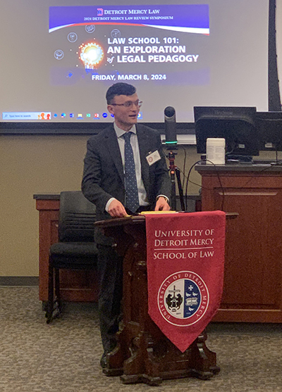 Kevin Lynch speaks at a podium during Law Review's annual symposium.