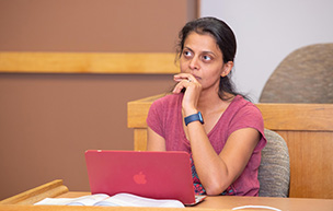 A student uses her computer during an MBA class.