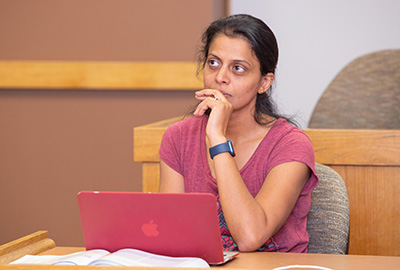A student uses her computer during an MBA class.