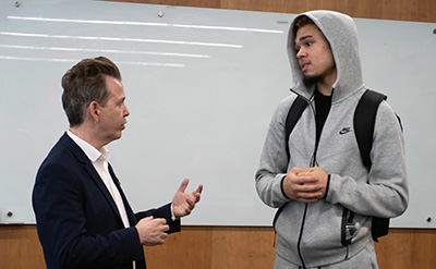 Neil Mandt talks with a UDM student after his talk on the McNichols Campus.