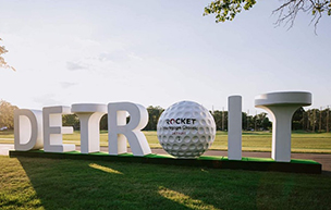A sculpture promoting the PGA Tour's Rocket Mortgage Classic at the Detroit Golf Club. White letters spelling out Detroit make up the sculpture with the 'O' being a giant PGA golf ball with the Rocket Mortgage logo on its center.
