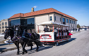 Horse drawn carriages outside of the Student Fitness Center at the Titan Winter Blast.