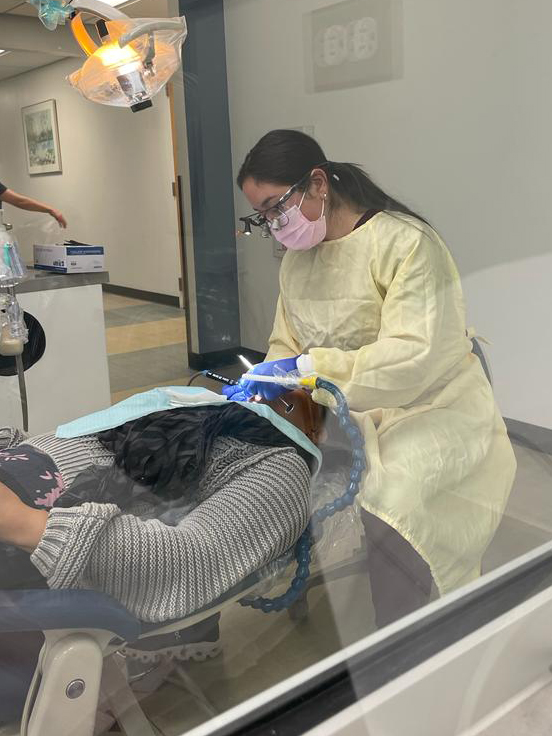 Andrade works on a patient in the School of Dentistry.