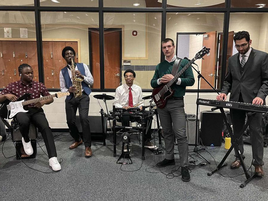 Five members perform inside of the Student Fitness Center.