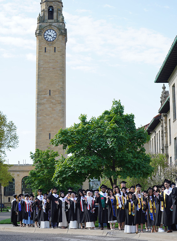 Graduates lineup outdoors prior to a ceremony
