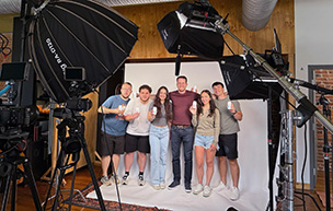 Meena Hanna and Malena Gjorgjevski pose for a picture with Carpe employees after shooting a commercial with the brand.