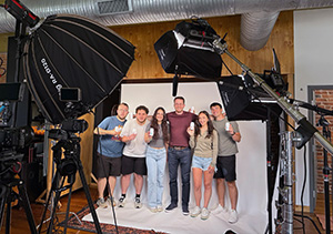 Meena Hanna and Malena Gjorgjevski pose for a picture with Carpe employees after shooting a commercial with the brand.