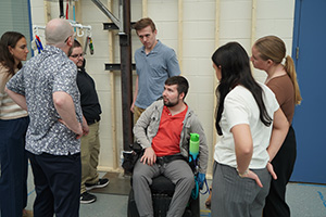 Jesse Lindlbauer sits next to his team after the Faces on Design presentation.