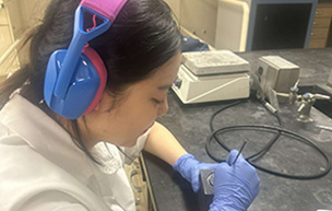 A student works on creating their medal.