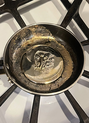 A medal lays on top of a stove.