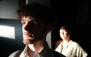 Josiah Martelle as Tom and Karen Kron Dickson '94 as Amanda in Detroit Mercy Theatre Company's The Glass Menagerie.