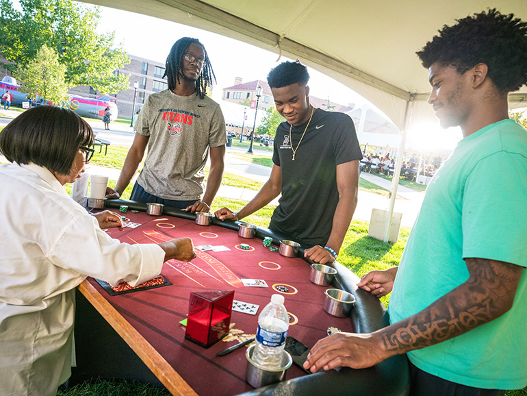 Students play a card game at Homecoming.